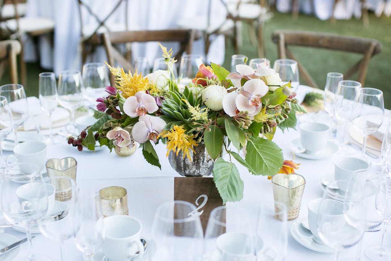Summer wedding with yellow and pink flower centerpiece | PartySlate