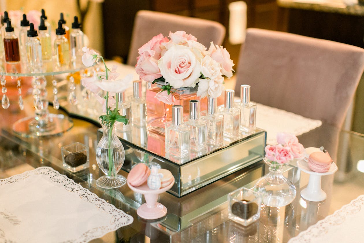 Perfume-making station with light pink flowers at wedding shower | PartySlate