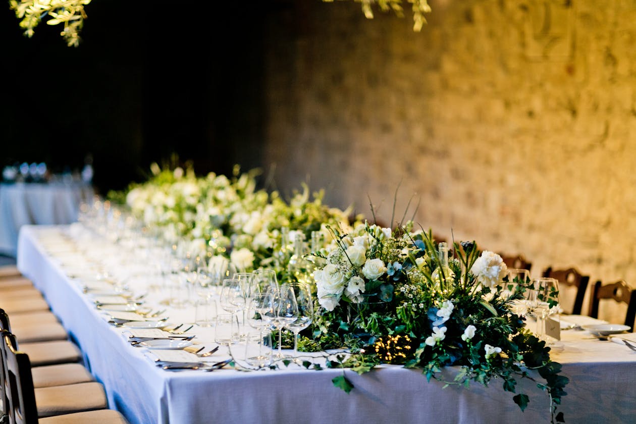 Greenery tablerunner with white blooms for wedding | PartySlate