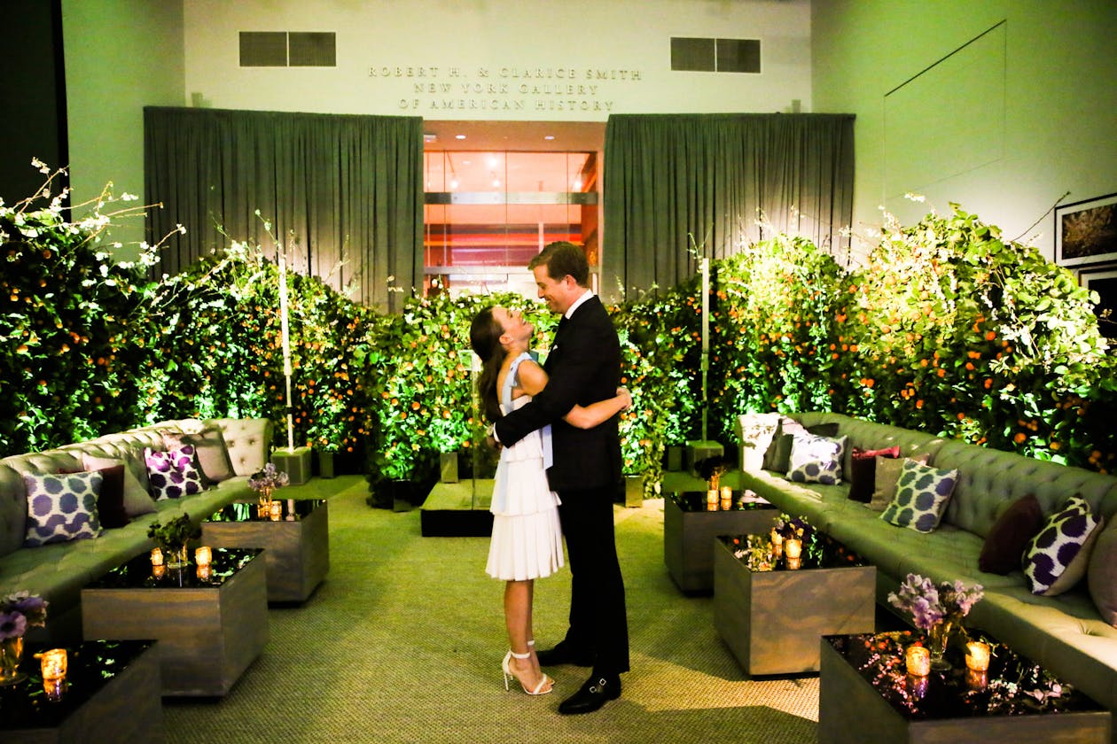 green velvet couch and floral décor at spring engagement party | PartySlate