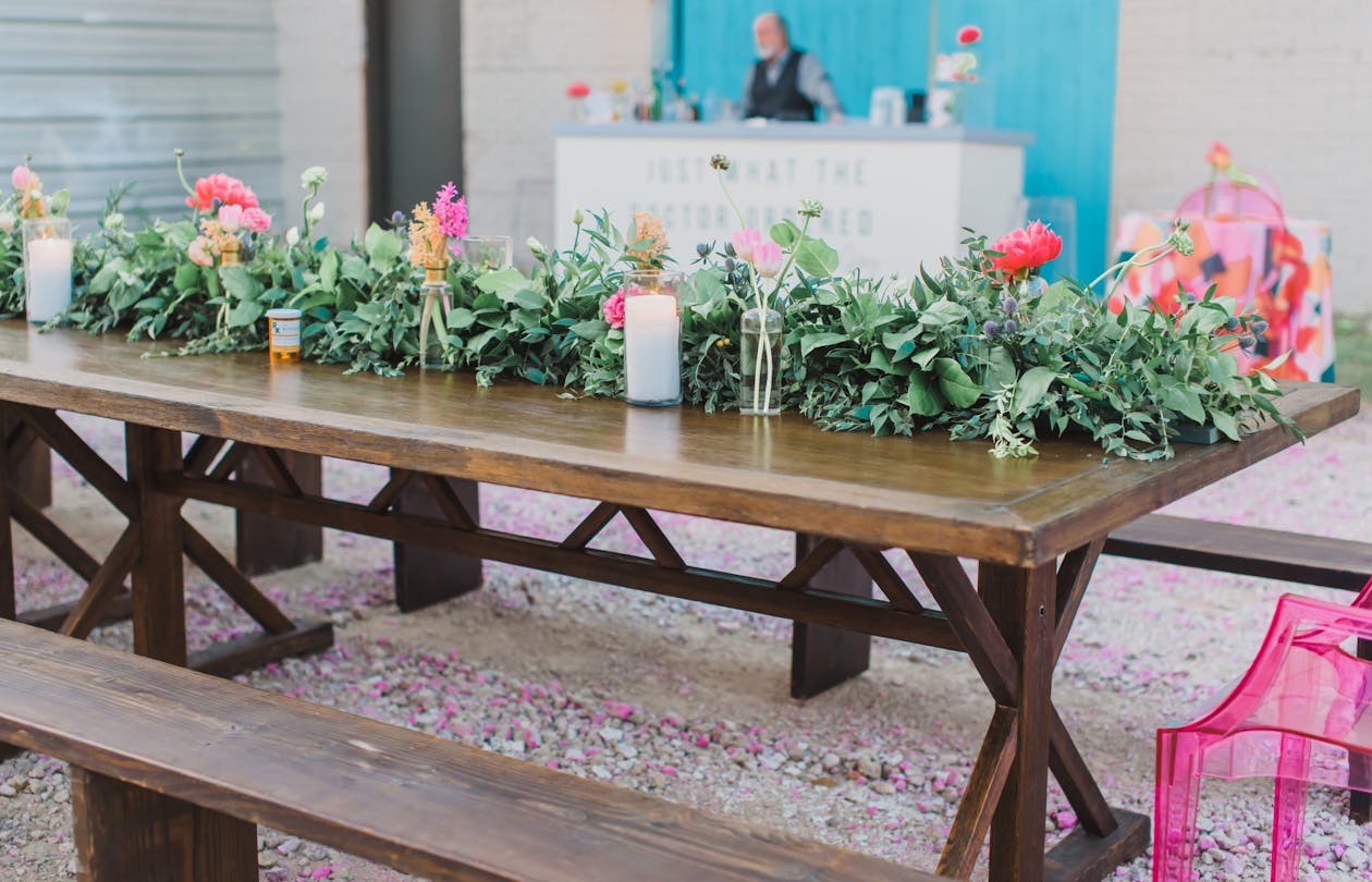 colorful spring engagement party picnic tablescape with greenery and bright florals | PartySlate