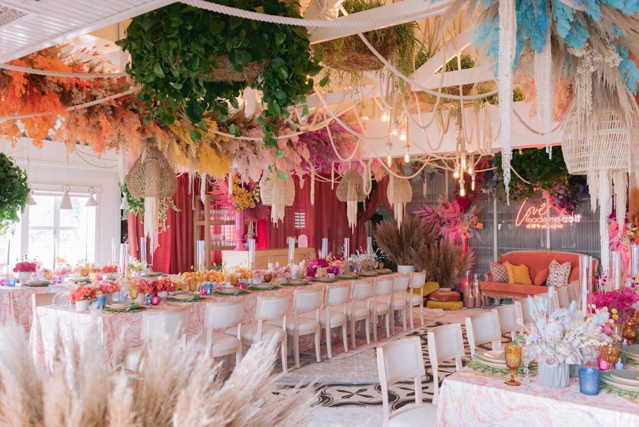 colorful and whimsical bohemian engagement party theme with neon sign and ceiling décor | PartySlate