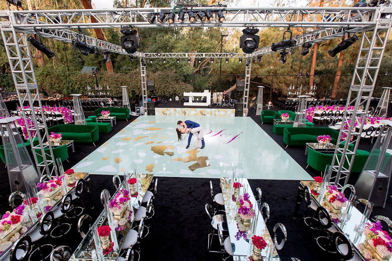colorful glamorous outdoor engagement party with dance floor and canopy | PartySlate