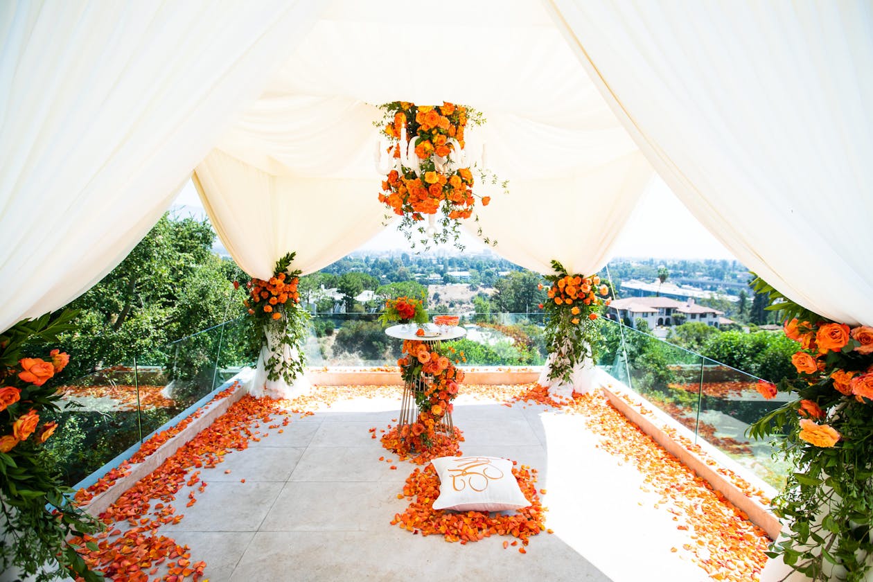 orange and floral summer engagement party overlooking the city at private residence under a white tent | PartySlate