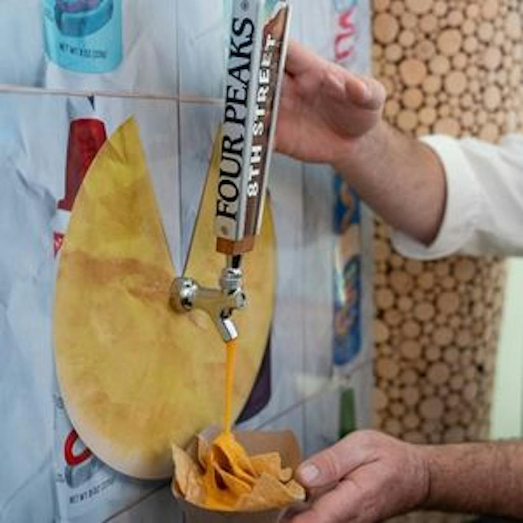 Self-serve cheese nacho cheese wall at corporate event | PartySlate