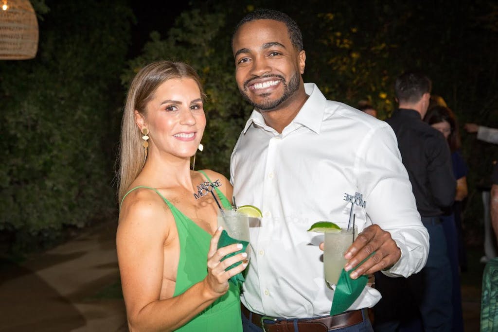 Bride and groom cheers with custom cocktails at tropical boho welcome party | PartySlate