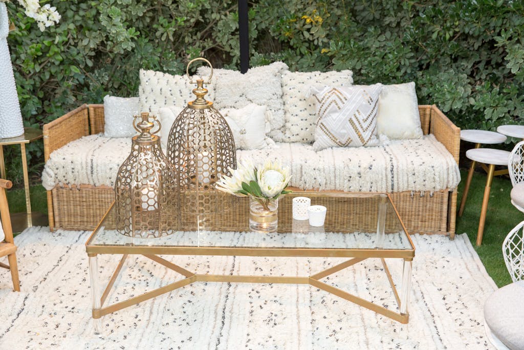 Welcome party lounge area with white seating and gold details | PartySlate