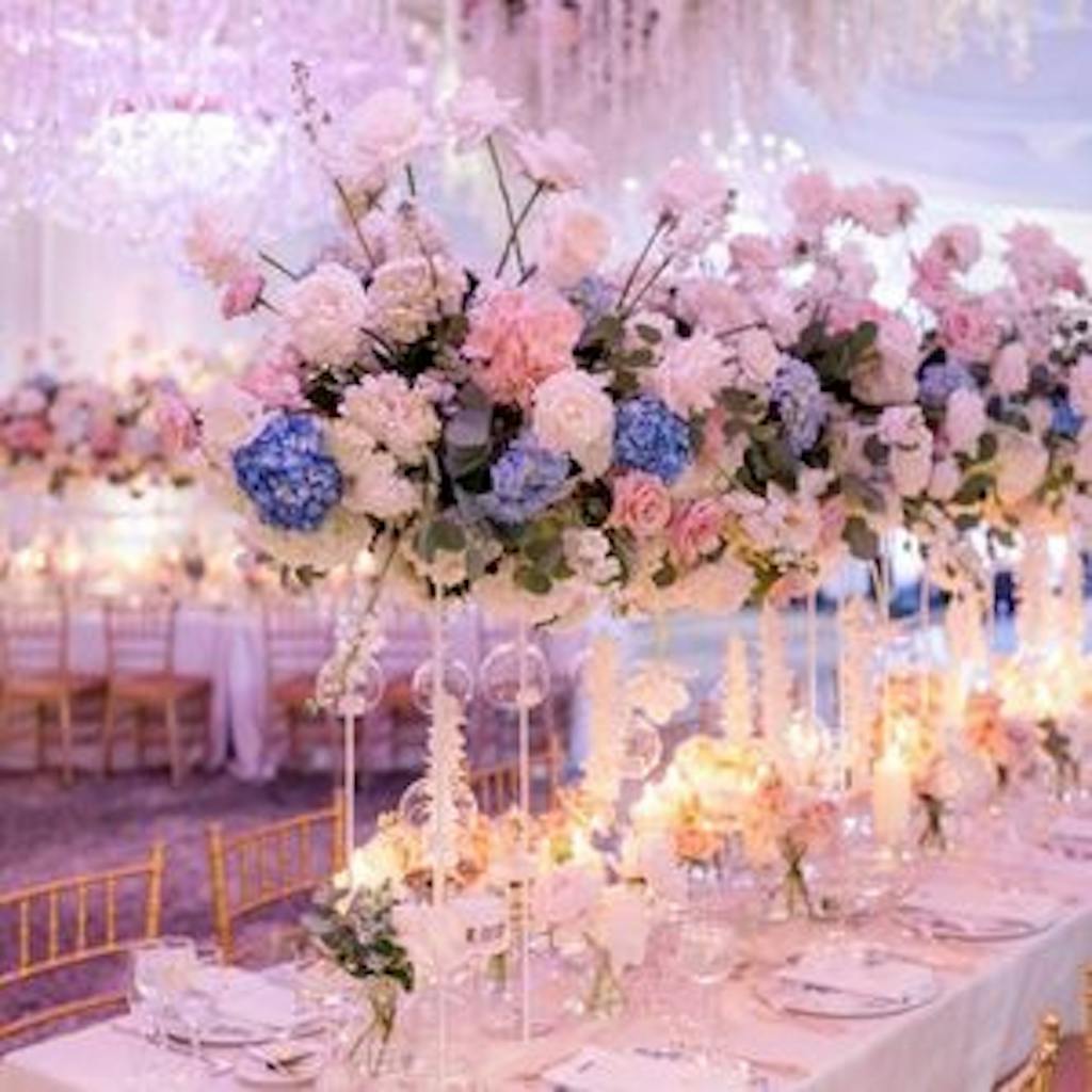Pink and blue floral wedding centerpieces at ballroom wedding.