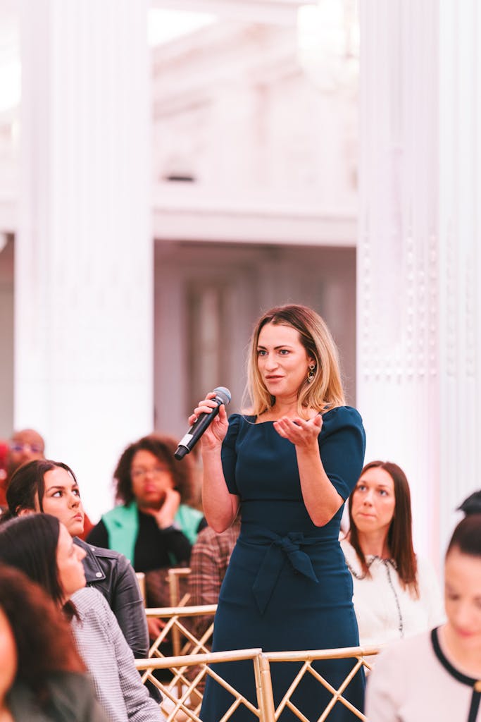 Women asking a question to the panelists