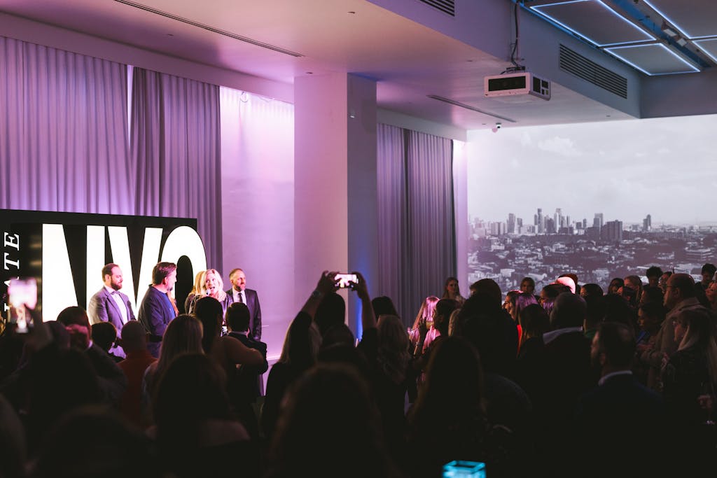 Industry professionals speaking on stage at PartySlate event