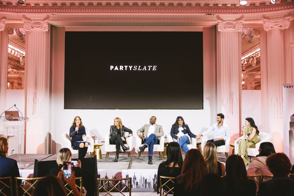 Panelists presenting at a PartySlate educational industry event