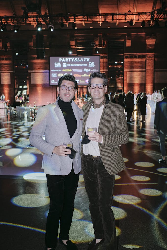 Two guests posing for a picture at the party