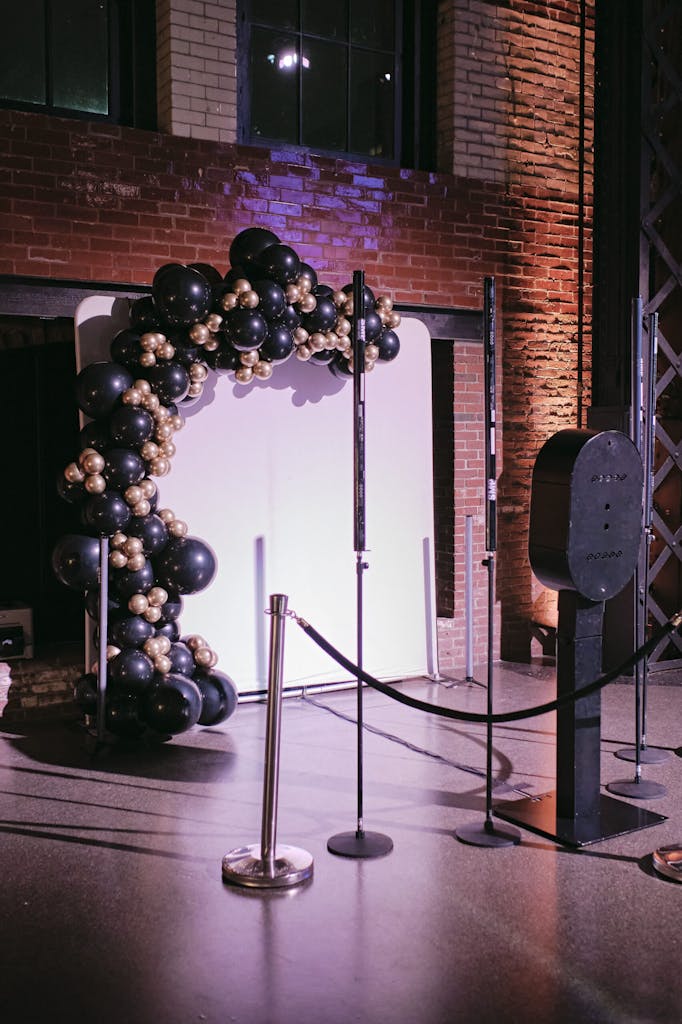 Photo booth backdrop with black and gold balloons